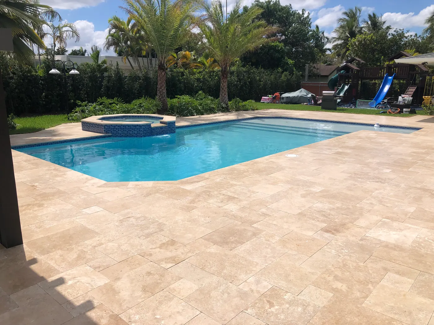 Travertine pool deck finished for barefoot comfort and grip